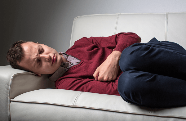 Young man suffering from severe belly pain
