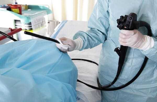 Doctor holding endoscope before colonoscopy
