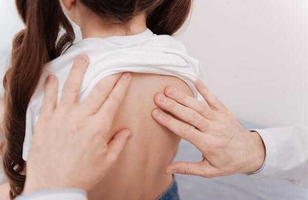 Excellent trained rheumatologist seeing signs of scoliosis