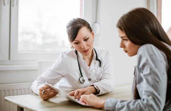 female doctor giving advice to a female patient about multiple sclerosis